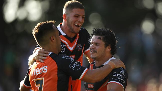 Luke Brooks and Adam Doueihi mob new teammate James Roberts and he scored a trial in Sunday’s trial match against Manly (Photo by Mark Kolbe/Getty Images)