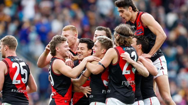 Essendon players celebrate after winning the match against the Brisbane Lions. Picture: Russell Freeman/AFL Photos via Getty Images