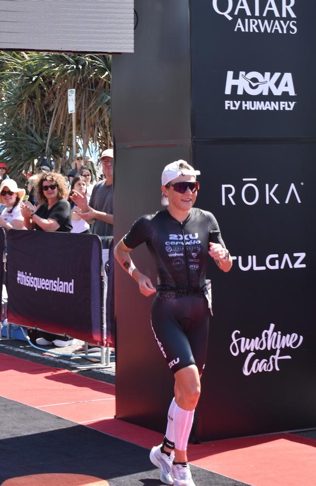 Athletes crossing the finish line at the Sunshine Coast Ironman 70.3 2023.