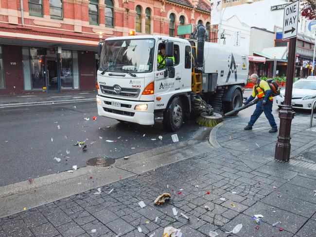 An Adelaide City Council worker cleans up litter early on a Sunday morning in Hindley Street. Picture: AAP/Brenton Edwards