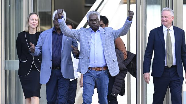 Gumatj leaders Jawa Yunupingu, centre, and Balupalu Yunupingu, left, with lawyer Sean Bowden, outside the High Court in Canberra after winning the landmark court case of his late brother Galarrwuy Yunupingu. Picture: NewsWire / Martin Ollman