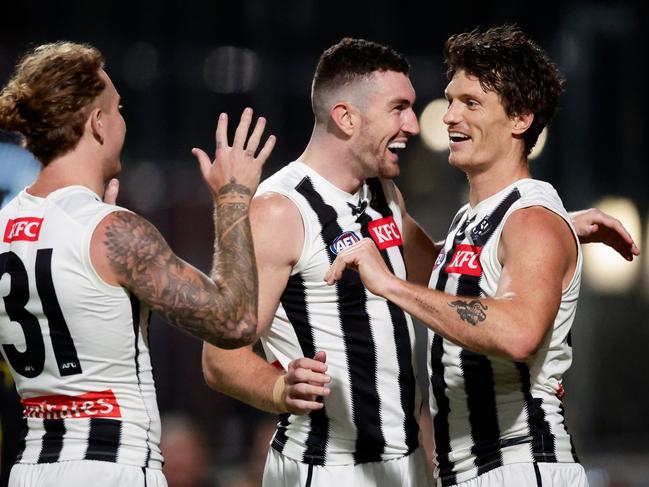 Brody Mihocek of the Magpies (R) celebrates a goal with teammates Daniel McStay and Beau McCreery during the pre-season. (Photo by Dylan Burns/AFL Photos via Getty Images)