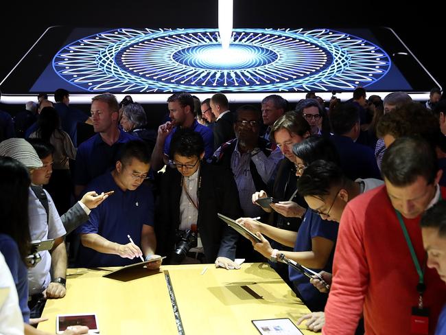 Attendees inspect the new iPad Pro during the 2017 Apple Worldwide Developer Conference. Picture: Getty/AFP