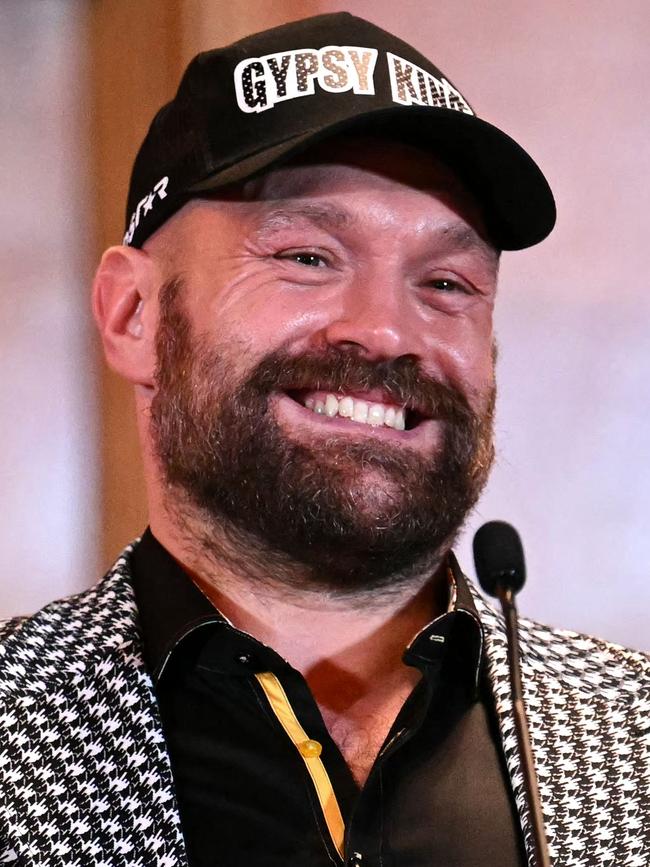 Despite losing his titles, Fury is rolling in it. (Photo by JUSTIN TALLIS / AFP)