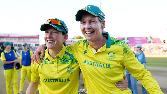 BIRMINGHAM, ENGLAND - AUGUST 07: Megan Schutt and Meg Lanning of Team Australia celebrate after winning the gold medal following the Cricket T20 - Gold Medal match between Team Australia and Team India on day ten of the Birmingham 2022 Commonwealth Games at Edgbaston on August 07, 2022 on the Birmingham, England.  (Photo by Alex Davidson/Getty Images)