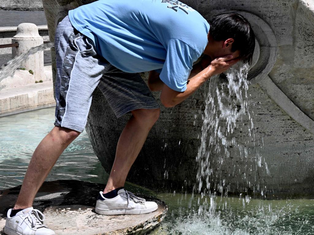 A boy cools down at the Barcaccia fountain in front of the Scalinata di Trinita dei Monti (Spanish Steps) in Rome. Picture: AFP