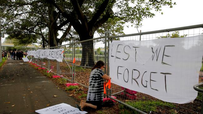 A protester puts up a sign about trees being removed along Anzac Pde Moore Park / Picture: John Grainger