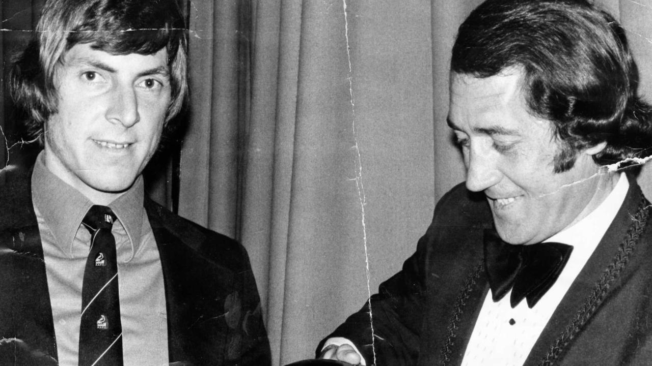 Russell Ebert is congratulated by John Cahill after winning his third Magarey Medal in 1976.