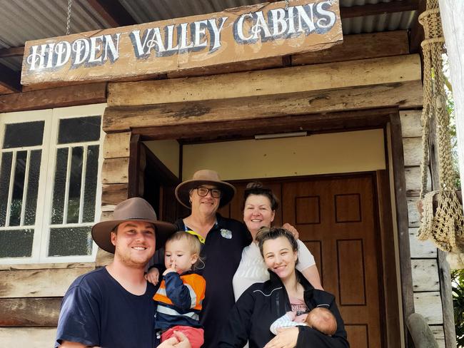 Steve and Sonia Ellery with Kurt and Tahlia Harlow, holding sons Billy and Jack, outside the entrance to Hidden Valley Cabins. Photo: Facebook