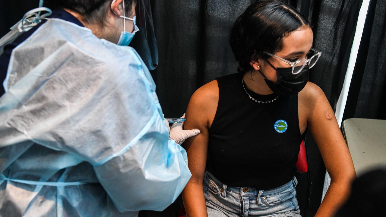 A health care worker administers a Covid-19 vaccine to 15-year-old Valentina Jimenez during a vaccination Florida where Delta is surging. Picture: Chandan Khanna/AFP