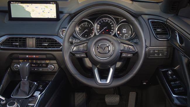 The Mazda interior is classy but is starting to show its age.