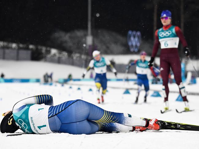 Sweden’s Stina Nilsson collapses onto the snow after crossing the finish line to win gold in the women’s cross-country individual sprint classic final at the Alpensia cross country ski centre during the Pyeongchang 2018 Winter Olympic Games on February 13, 2018 in Pyeongchang. Picture: AFP