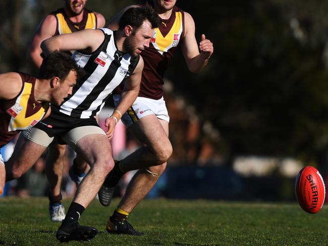 Nathan Hicks chases the ball for Scoresby. Picture: James Ross/AAP