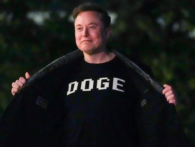 Elon Musk shows off a shirt that says "DOGE" as he walks on the South Lawn of the White House after stepping off Marine One upon arrival to the White House. Picture: AFP