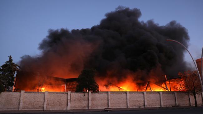 A fire burns after explosions at a security compound that houses the Syrian Military Intelligence Interrogation Division, in Damascus, Syria.