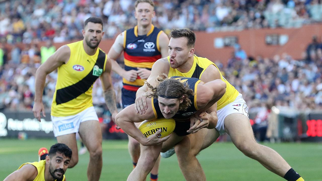 Noah Balta tackles Crow Sam Berry on Saturday. Picture: Sarah Reed/AFL Photos