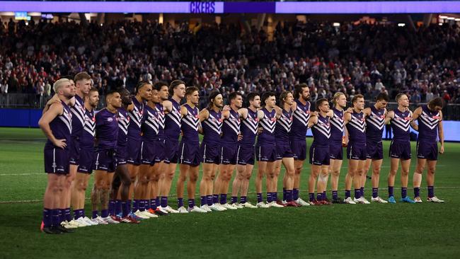 The teams pay their respects to former player Cameron McCarthy. (Photo by Will Russell/AFL Photos via Getty Images)