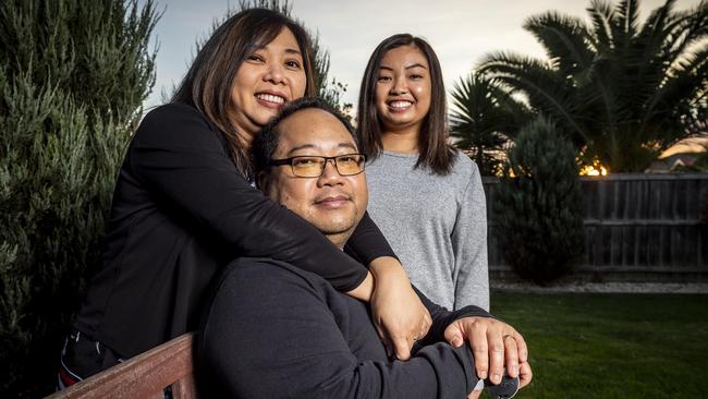 Michael Rojales, with his wife, Rachel and daughter, Megan, now suffers from fatigue and uses a cane to walk. Picture: Jake Nowakowski