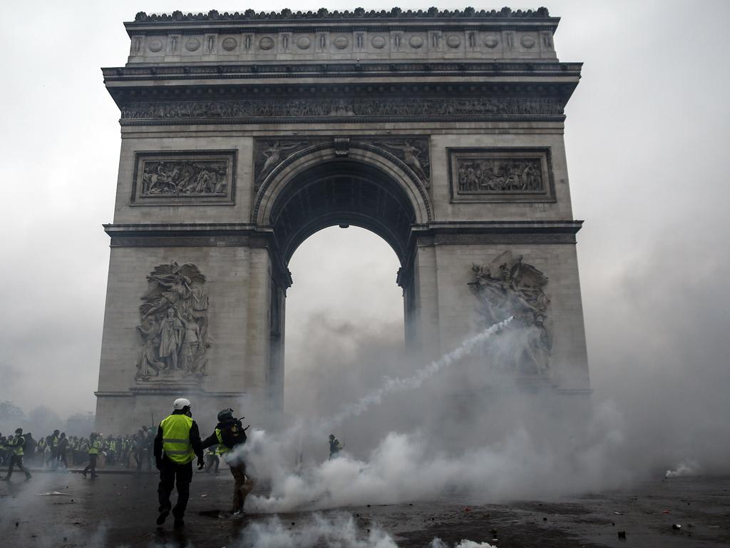 Demonstrators clash with riot police at the Arc de Triomphe during a protest of Yellow vests (Gilets jaunes) against rising oil prices and living costs in Paris. Picture: Abdulmonam Eassa