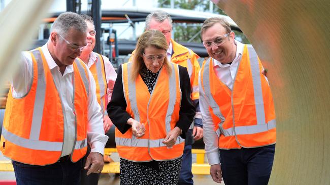 Deputy Premier Steven Miles (right) with Mayor Jenny Hill and Mr Stewart inspect a section of pipe at the Iplex plant in Townsville earlier this year. Picture: Natasha Emeck