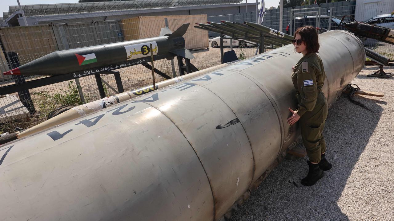 A member of the Israeli military stands next to an Iranian ballistic missile which fell in Israel on the weekend. Picture: AFP.