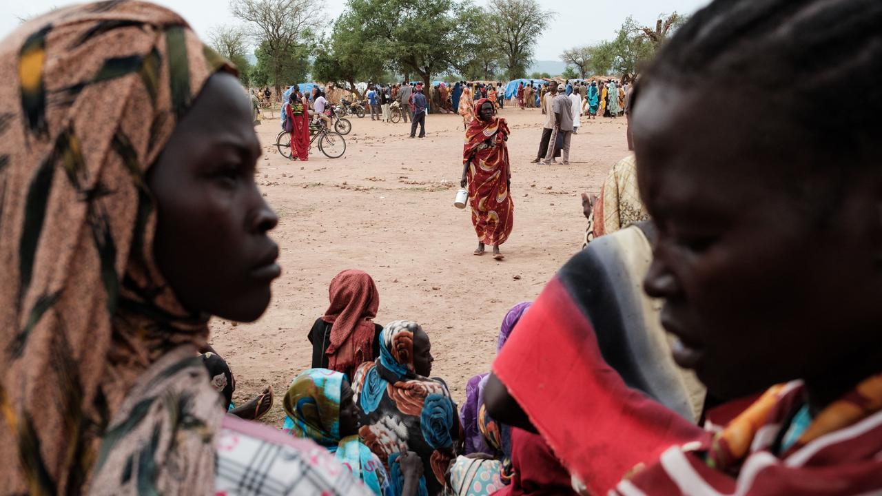 People wait to receive food cards after registering as new arrivals at a camp for internally displaced persons (IDP) in Agari, North Kordofan. Picture: Guy Peterson/AFP