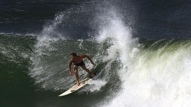 A surfer at Snapper Rocks on the Gold Coast on Sunday. Picture: Lyndon Mechielsen