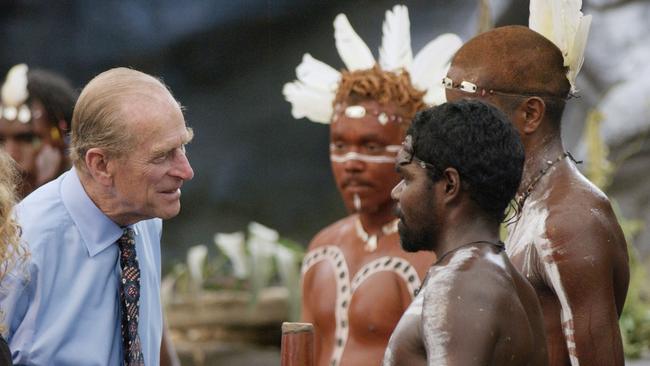 The Duke of Edinburgh talks to Aboriginal performers after watching a culture show at Tjapukai Aboriginal Culture Park, Cairns, Queensland, Australia. The Duke surprised the aborigines when he asked them "Do you still throw spears at each other?" (Photo by Fiona Hanson – PA Images/PA Images via Getty Images)