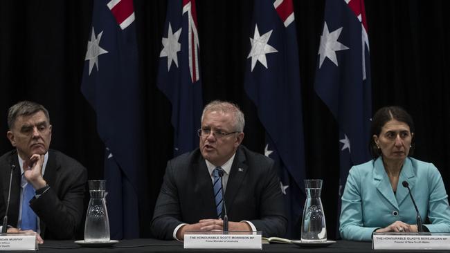 Professor Brendon Murphy, Scott Morrison and NSW Premier Gladys Berejiklian at a press conference announcing the banning of crowds above 500. Picture: Getty