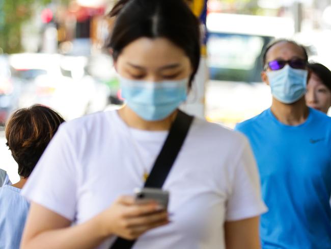 SYDNEY, AUSTRALIA - NewsWire Photos JANUARY, 11, 2021: People seen wearing face masks while walking through the central shopping district of Chatswood inline with the new rules on mandatory mask wearing for Covid-19 in Sydney, Australia. Picture: NCA NewsWire / Gaye Gerard