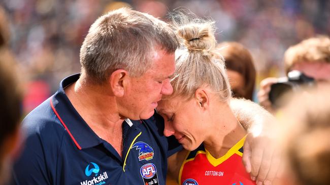 Erin Phillips, left, is consoled by her father and Port Adelaide legend Greg Phillips. Picture: Daniel Kalisz/Getty Images