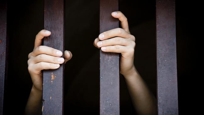 Prisoner, hands holding bars, jail, behind bars, children behind bars, asylum seeker generic, detention center, detained, jailed, shame, sadness, mental health, restriction, limitation generic, thinkstock