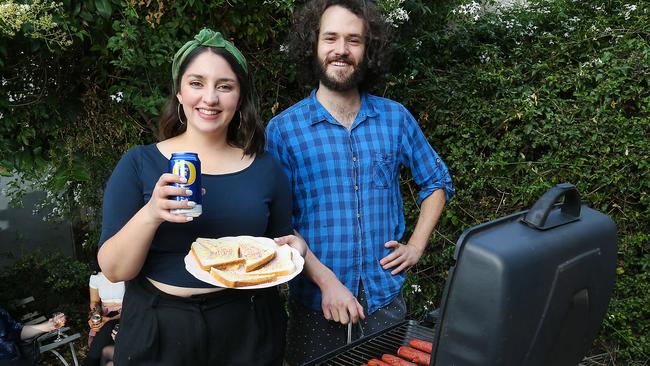 Grace McKinnon and Harry Vincent embrace the typical Aussie barbecue. Picture: Ian Currie