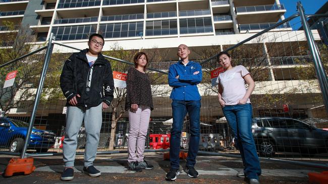 Upset and desperate residents of Mascot Towers, Jimmy Ye, Kasumi Kitano with her husband Thomas Deakin and Angel Chen, outside their building in Mascot, today. Picture:Justin Lloyd