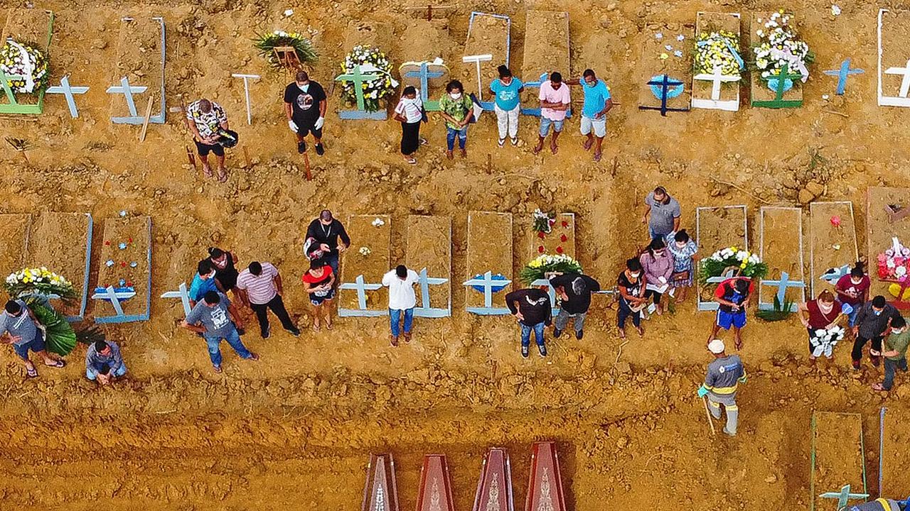 Aerial picture showing a burial taking place at an area where new graves have been dug. Picture: AFP