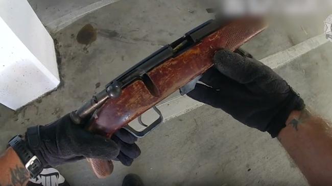 Police video shows officers finding this gun in the shopping centre carpark. Pictures and video QPS