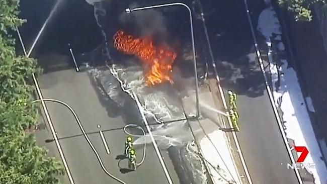 Firefighters are using water and foam to contain the blaze, while also putting environmental protection measures in place such as covering drains with booms. Picture: Seven News