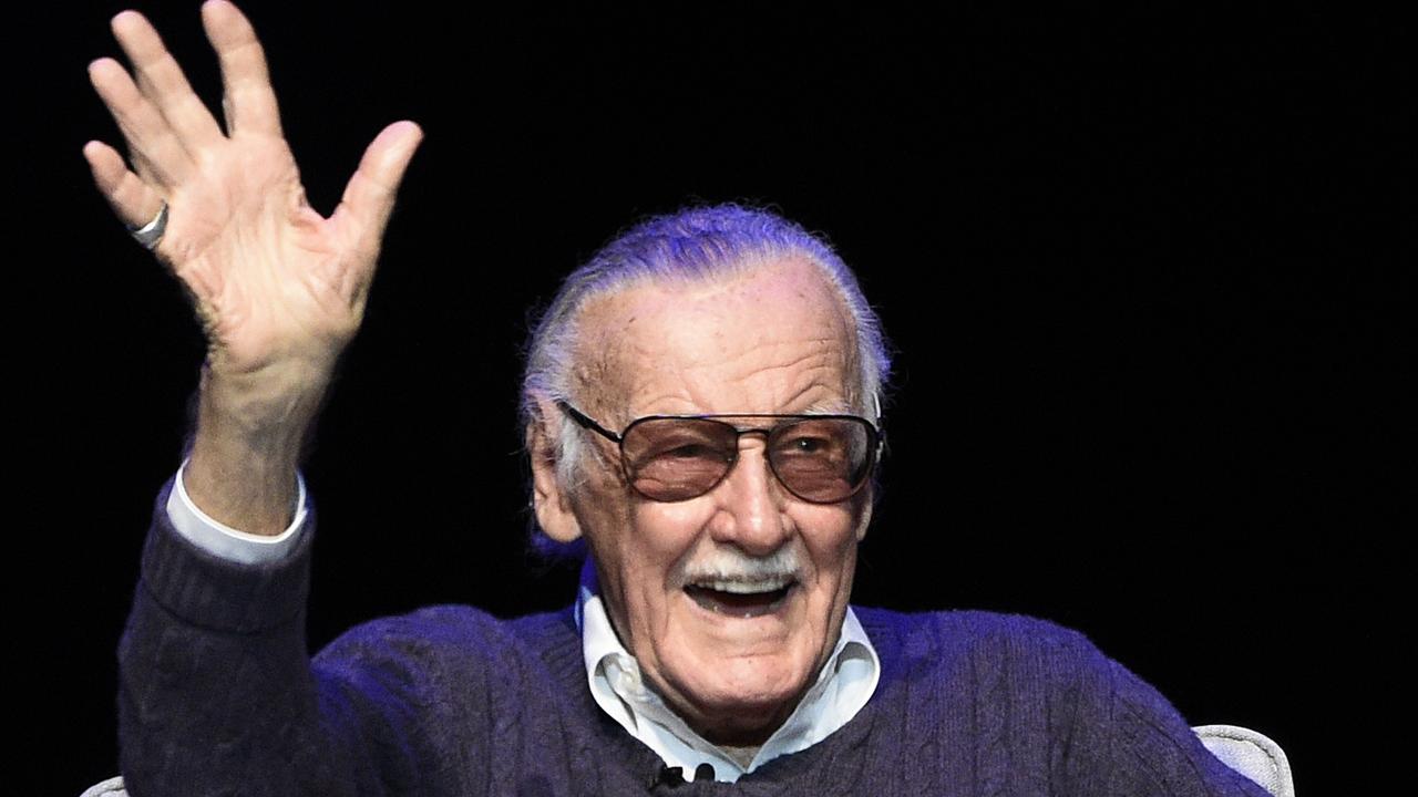 Stan Lee waves to the audience after being introduced on stage at a tribute. Picture: AP