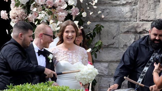 Nassib Thoumi and Paula Pratt walk out of church after getting married on Sunday.