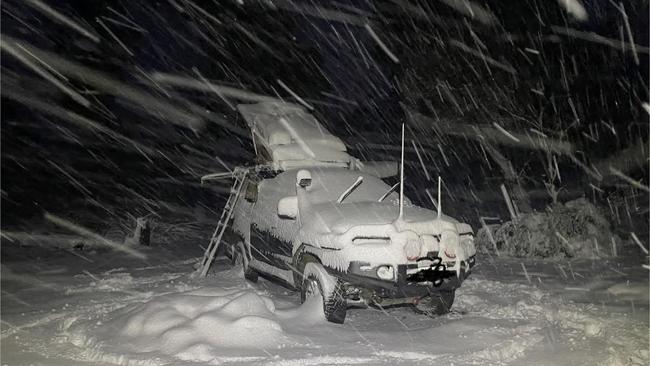 A four-wheel-drive blanketed by snow near Little Pine Lagoon in the Central Highlands on Thursday. Picture: Luke Stahl/Facebook