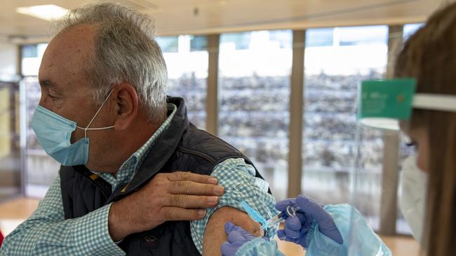 Will living alongside COVID resemble our adaption to the strains of influenza still with us a century after the infamous pandemic? In Spain this month, a health-care worker administers a flu vaccine to a man in a Madrid government measure to help tackle the resurgent coronavirus pandemic. Picture: Getty Images