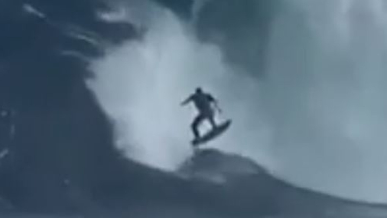 Moment surfer shredded by monster wave