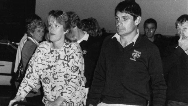 Robbie Muir leaves Thebarton Oval with wife Lynette after being reported for striking John Roberts in 1985.