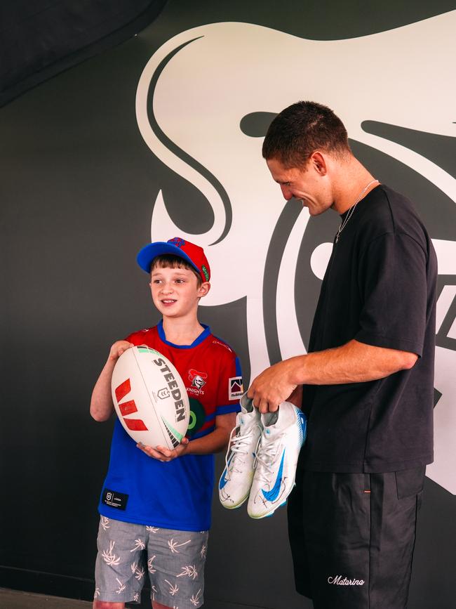 Knights star Kalyn Ponga with fan Dylan Moon.