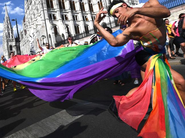 (FILES) People take part in the LGBTIQA+ Pride Parade in Budapest on July 23, 2022. Hungarian lawmakers passed a bill on MArch 18, 2025 aimed at banning an annual Pride march, in what critics have slammed as the latest effort to crack down on the country's LGBTQ community. (Photo by Ferenc ISZA / AFP)