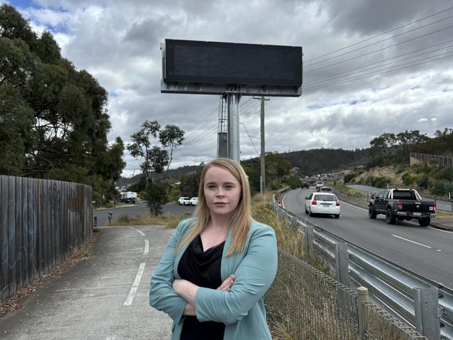 Labor transport spokeswoman Meg Brown in front of a blank electronic traffic sign on the South Arm Highway. Picture: Simon McGuire.