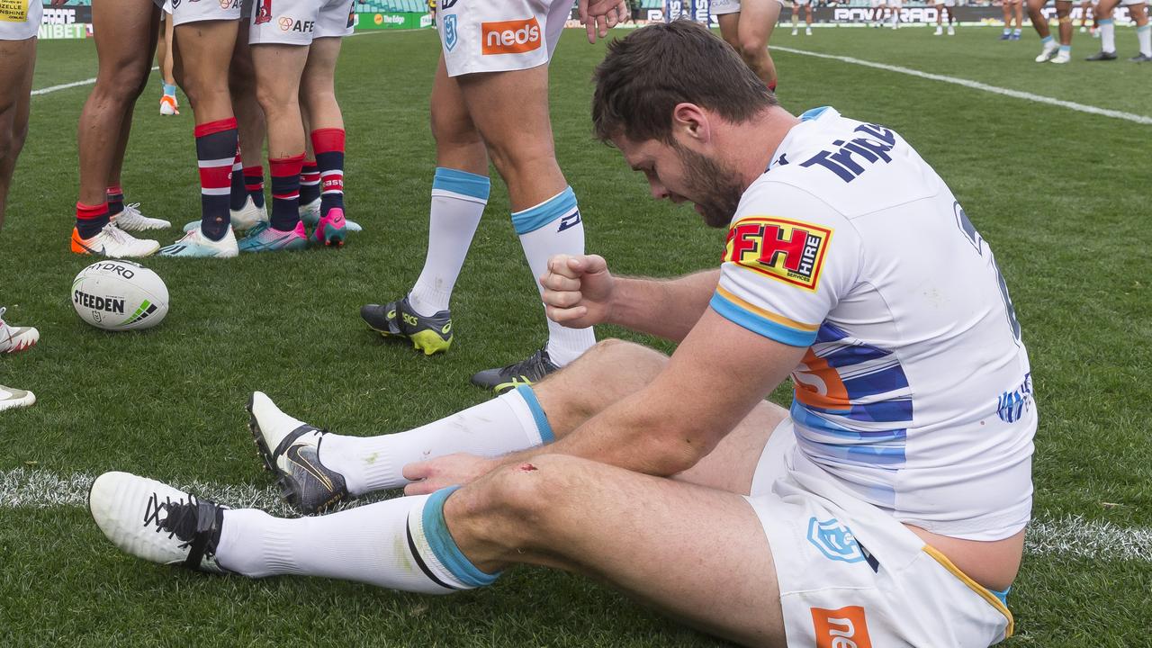 Titans player Anthony Don is dejected after another Roosters try.