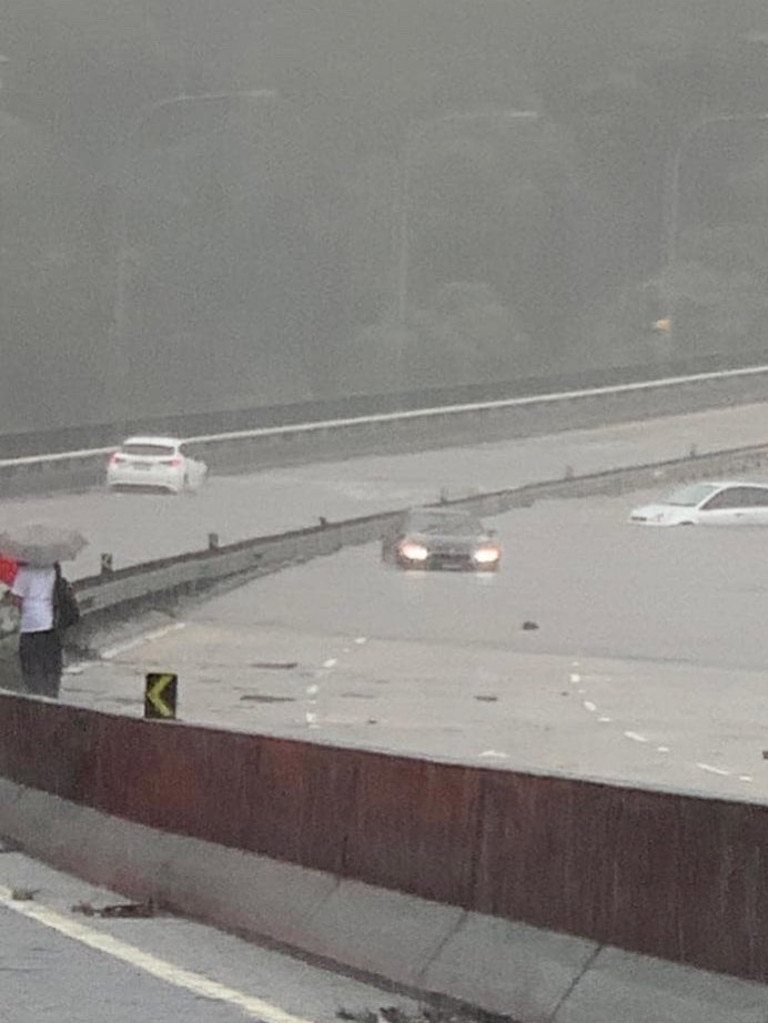 Cars attempting to cross floodwaters on the Roseville Bridge were left stranded. Picture: Facebook