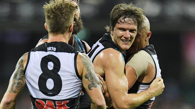 Jared Polec of the Power celebrates kicking a goal with teammates.