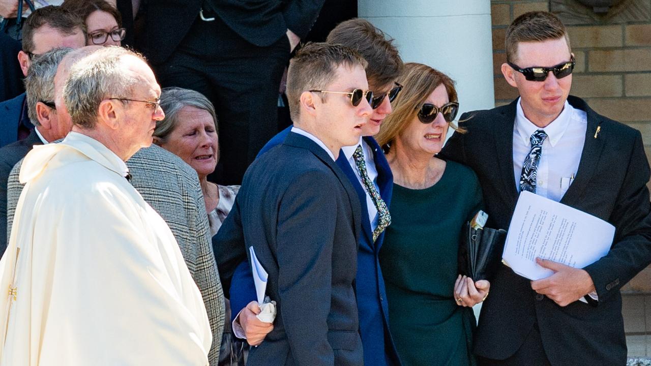 Erin Mulherin with her three sons at Tim Mulherin’s State funeral. Photo : Daryl Wright